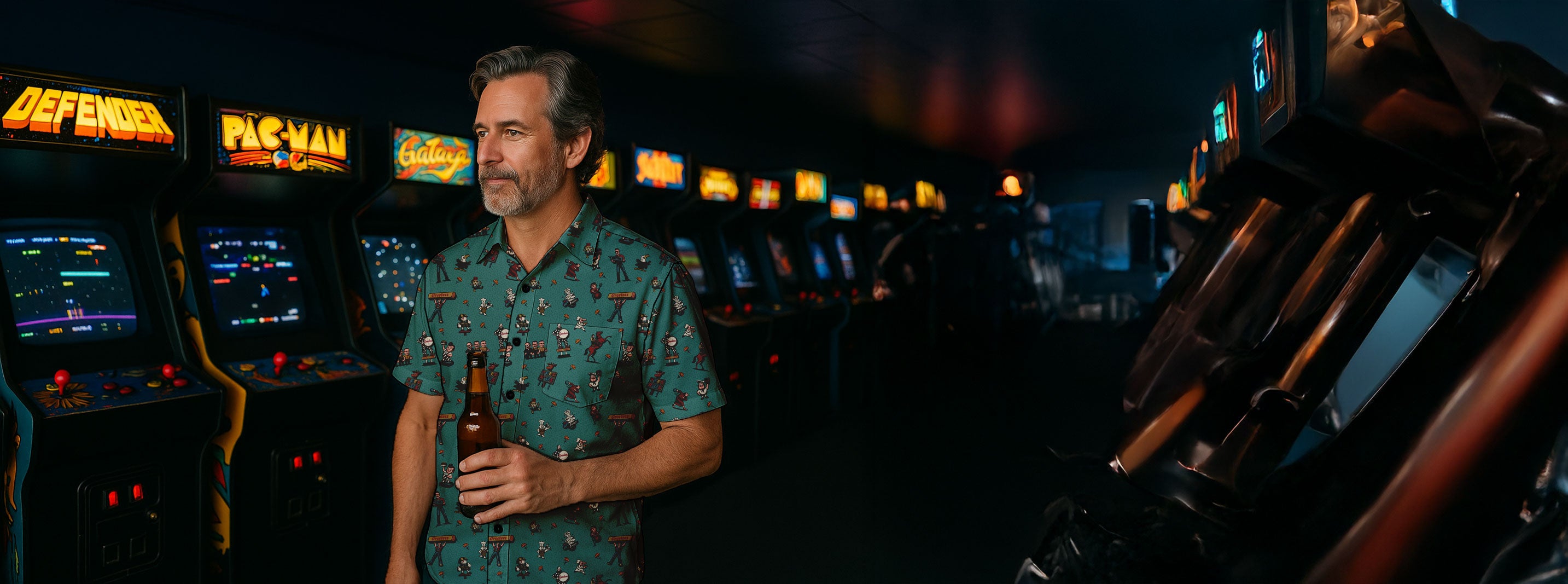 Man standing in front of vintage arcade machines in a dark back